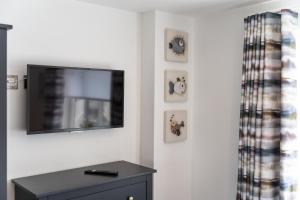 a living room with a flat screen tv on a wall at No.1 The Prom in Westward Ho