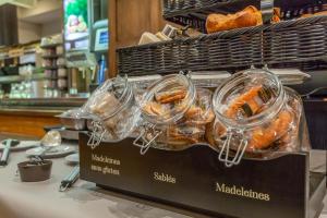 a display of bread and pastries on a counter in a store at The Originals Access, Hôtel Bourges Gare in Bourges