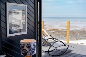 a view of the beach from a room with a bench at No.1 The Prom in Westward Ho
