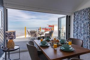 a dining room with a table and a view of the ocean at No.1 The Prom in Westward Ho
