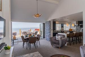 a dining room and living room with a view of the ocean at No.1 The Prom in Westward Ho