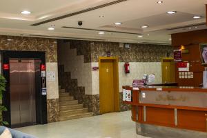 a lobby of a store with stairs and a counter at Quiet Rooms 1 Serviced Apartments in Riyadh
