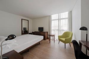 Postel nebo postele na pokoji v ubytování Neat Hotel Avenida