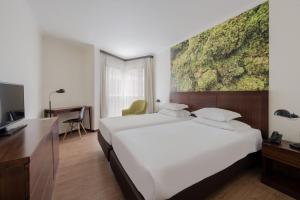 Postel nebo postele na pokoji v ubytování Neat Hotel Avenida