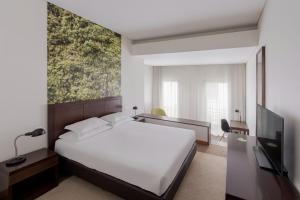 TV a/nebo společenská místnost v ubytování Neat Hotel Avenida