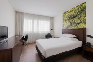 TV a/nebo společenská místnost v ubytování Neat Hotel Avenida