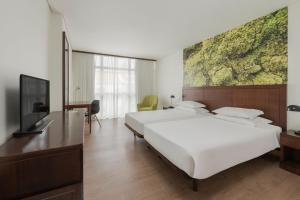 TV a/nebo společenská místnost v ubytování Neat Hotel Avenida