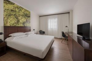 TV a/nebo společenská místnost v ubytování Neat Hotel Avenida