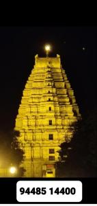 a tall yellow building with a light on top at Royal Homestay New Hampi in Hampi