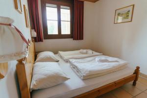 Postel nebo postele na pokoji v ubytování Apartment Zirbengeist Gerlitzen