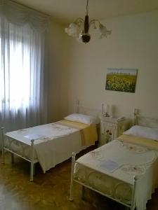 Postel nebo postele na pokoji v ubytování B&B Villa Adriano