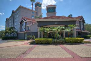 a hotel building with a clock tower on top of it at La Quinta by Wyndham Orlando I Drive/Conv Center in Orlando