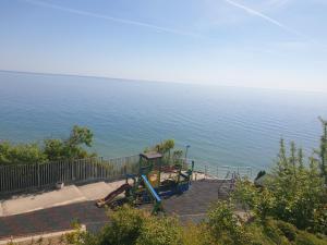 a person laying on a playground next to the water at Studio Silver Terace with Sea View for 4 person in Byala
