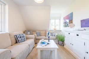 ein Wohnzimmer mit einer Couch und einem Tisch in der Unterkunft Haderslebener Str 28 in Westerland
