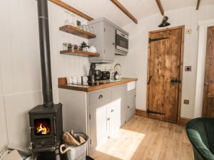 a kitchen with a wood stove in a room at Ewes Welcome in Cottingham