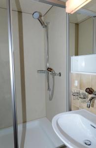 a bathroom with a shower and a sink at Gasthaus Engel in Sachseln