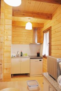 a kitchen in a wooden cabin with a sink at O Rincón das Rías Baixas in Bueu +39 photos