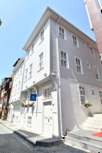 a white building with a white door on a street at Agras Hotel in Istanbul