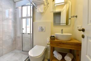 a bathroom with a toilet and a sink and a shower at Agras Hotel in Istanbul