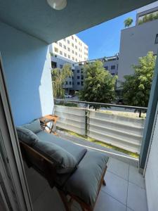 a balcony with a couch and a large window at Lovely Modern Apartment - Lake Jarun in Zagreb