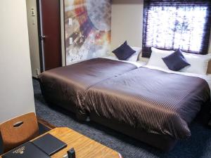 En eller flere senger på et rom på HOTEL LiVEMAX Kyoto Ekimae