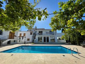 an exterior view of a house with a swimming pool at Templos Homes in Kyrenia