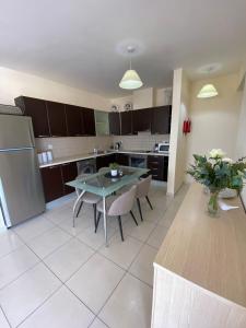 a kitchen and dining room with a table and chairs at Pyla Palms A1 204 in Pyla