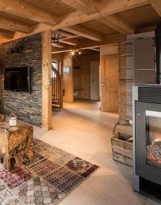 a living room with a stone wall and a fireplace at Chalet Claassen in Brandstätter