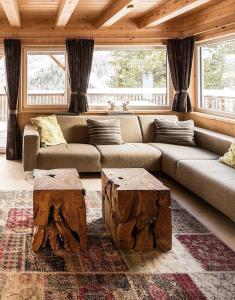 a living room with a couch and a tree stump tables at Chalet Claassen in Brandstätter