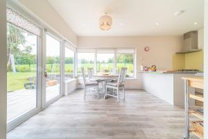 a kitchen and dining room with a table and chairs at 2 BED WATERFRONT PROPERTY - CLOSE TO COURTMACSHERRY in Cork
