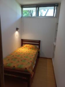 a bedroom with a bed in a room with a window at Parana Riverside Guest House - Posadas in Posadas