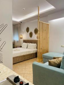 a hotel room with a bed and a couch at Summer Dreams Studios in Skala Potamias