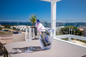 two glasses on a table with a view of the ocean at Lagos Atlantic Hotel in Lagos
