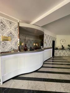 a lobby with a long white counter in a building at Haus Hennesburg, garni in Eisenach