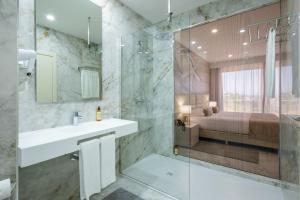 a bathroom with a sink and a shower at Lagos Atlantic Hotel in Lagos