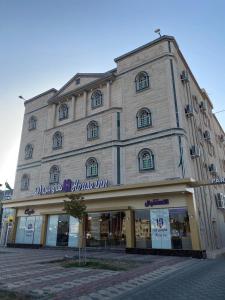 a large building on a street in front at هاوس إن House Inn in Najran