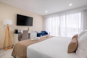a hotel room with a bed and a television at Lagos Atlantic Hotel in Lagos