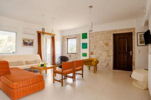 a living room with a couch and a table at Villa Vakirli in Loutra
