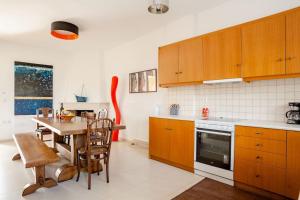 a kitchen with a table and a dining room at Villa Vakirli in Loutra