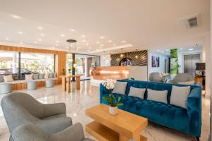 a living room with a blue couch and chairs at Lagos Atlantic Hotel in Lagos