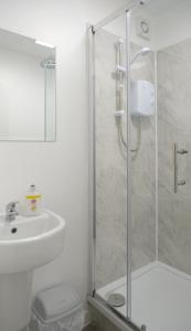 a bathroom with a shower and a toilet and a sink at The Kop End Hotel by Serviced Living Liverpool in Liverpool