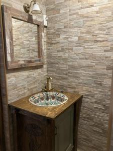 a bathroom with a sink and a mirror at Kisdió Vendégház in Dég