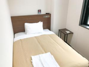 Letto o letti in una camera di HOTEL LiVEMAX BUDGET Nagoya Shinkansen-guchi