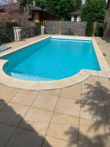 una piscina de agua azul en un patio en Chez les Michel en Viry