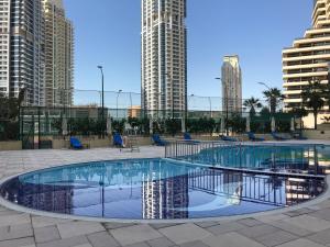 a swimming pool in the middle of a city with tall buildings at Frank Porter - Marina Terrace in Dubai