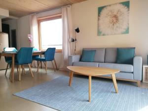 a living room with a couch and a table at Easy-Living Kriens Apartments in Luzern