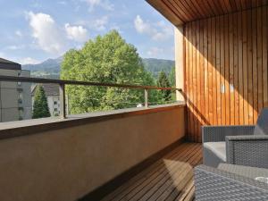 a balcony with a view of a tree at Easy-Living Kriens Apartments in Luzern