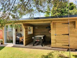 a small cabin with a ping pong table in it at 17 Costa Way in Pickering