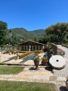 a garden with a pavilion with flowers and plants at Tradition Corse et Modernité A Cantina in Granace