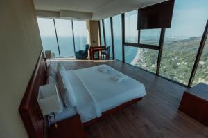 a hotel room with a bed and a large window at Litz Resort in Kvariati